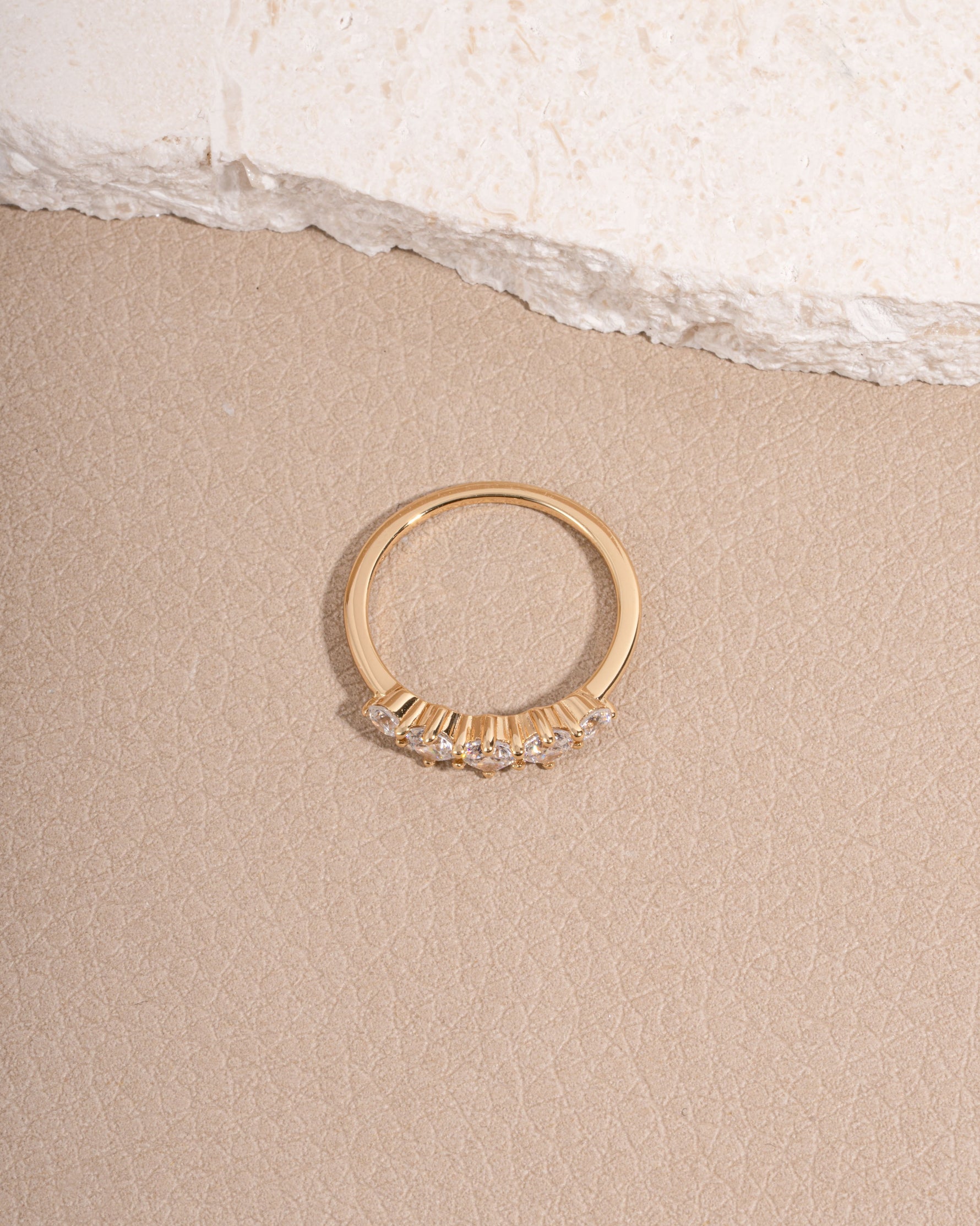 Gold bridal jewelry featuring a gemstone ring 
