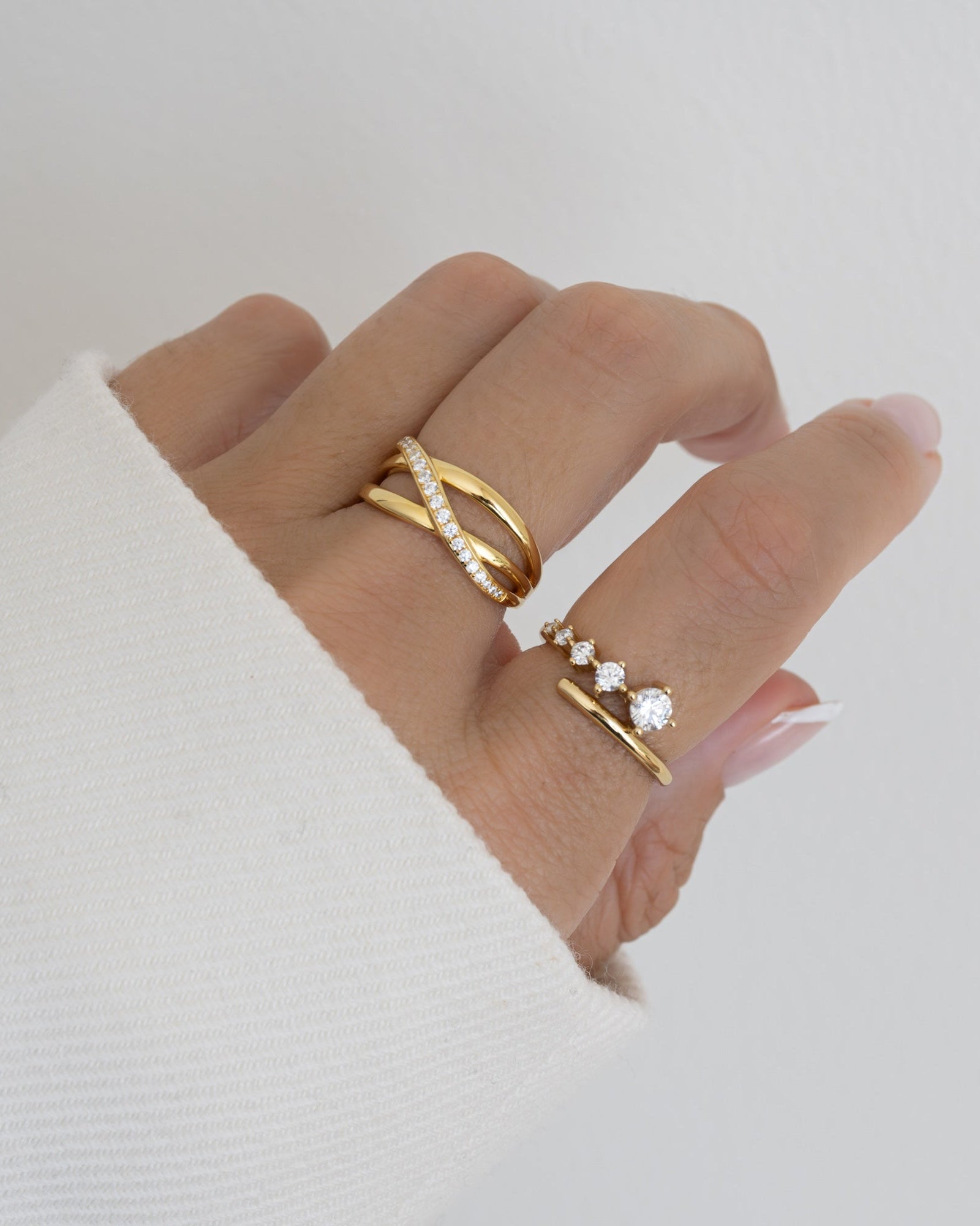 double band gold x ring on model and diamond bypass ring in 14k gold plating