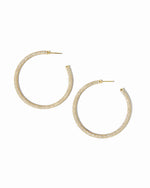 Gold hoop earrings on a white background