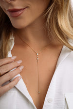 Model wearing gold diamond Y necklace
