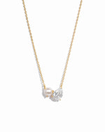 Necklace with a pearl and small diamond pendant on a gold chain against a white background