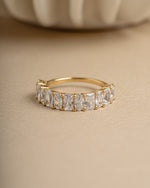 Gold diamond gemstone ring on beige background