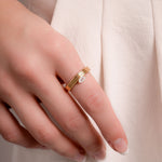 model wearing gold stacking ring featuring marquise stone