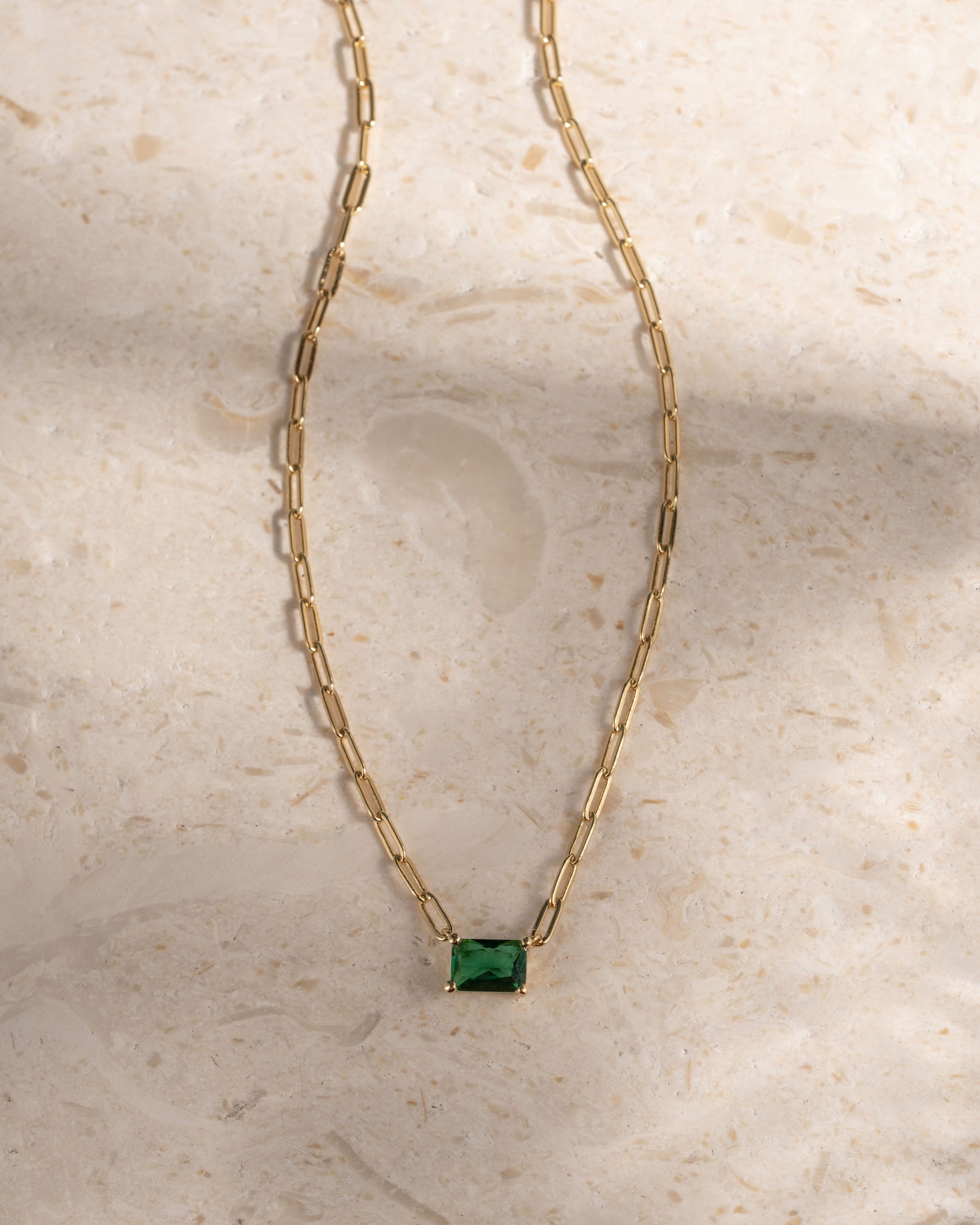 Gold paperclip layering necklace with emerald pendant 