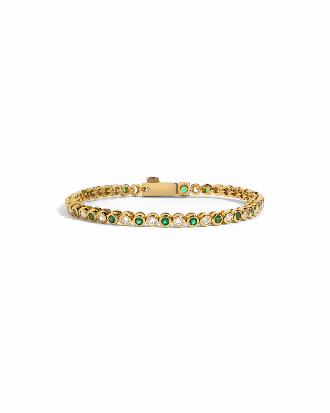 gold tennis bracelet with emerald green and white cubic zirconia stones