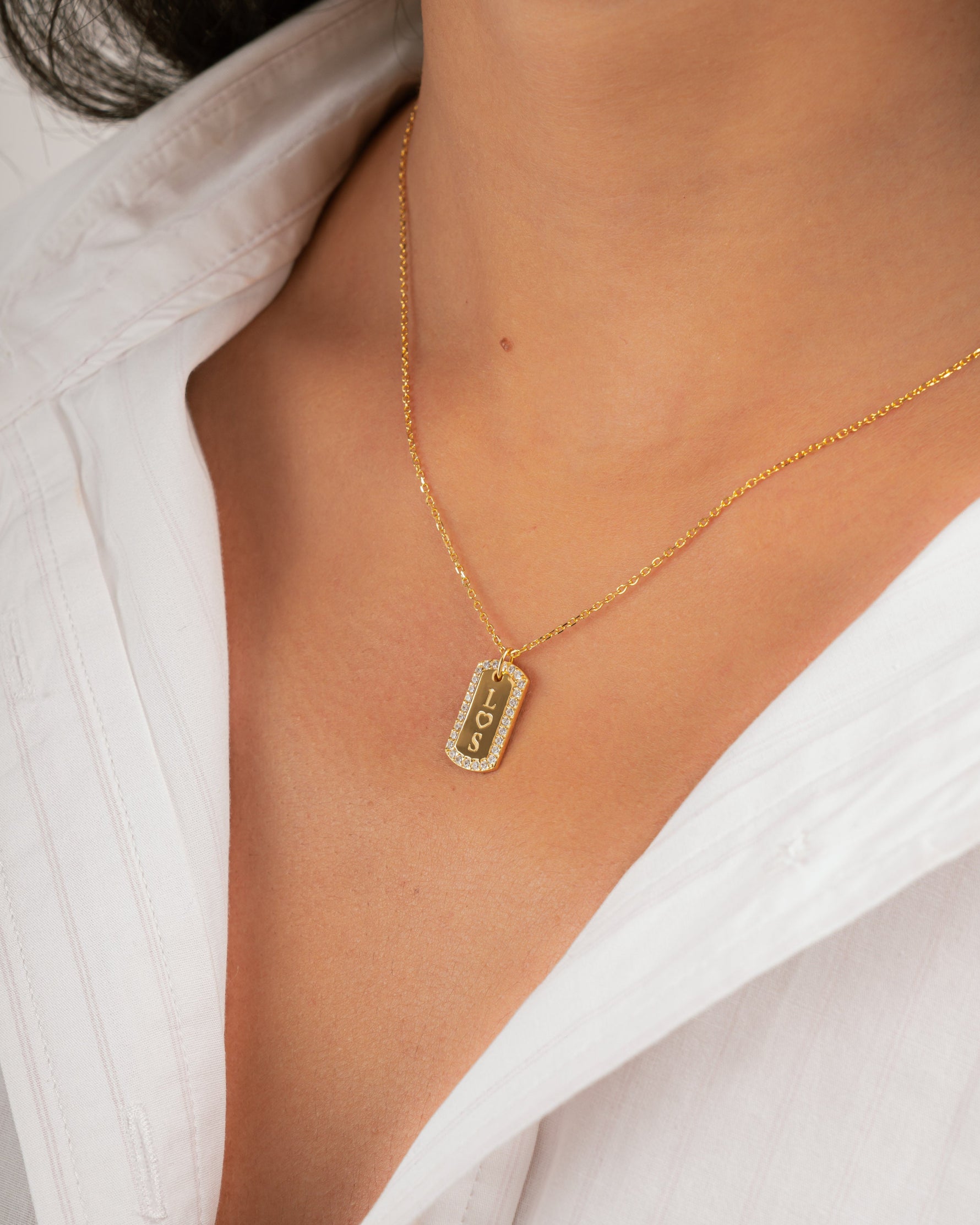 model wearing gold engraved necklace with cubic zirconia stones