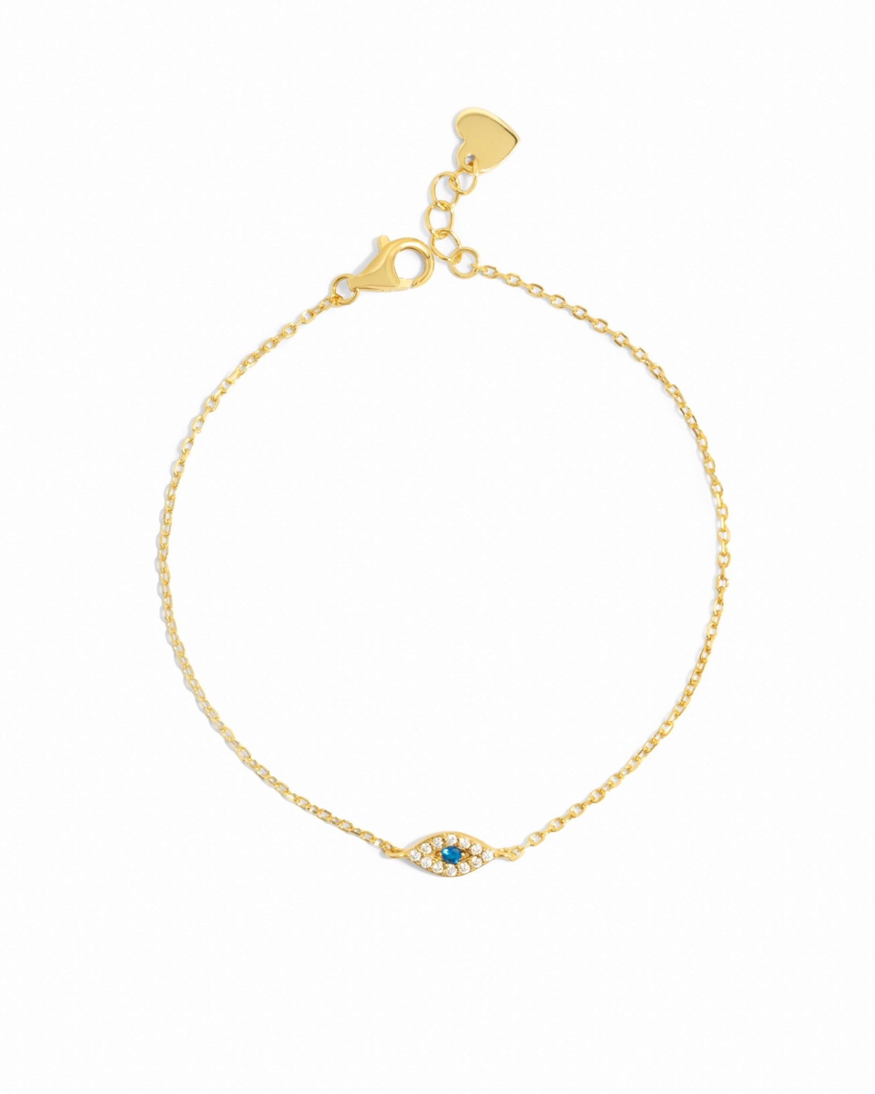 Gold bracelet with a small evil eye charm on a white background