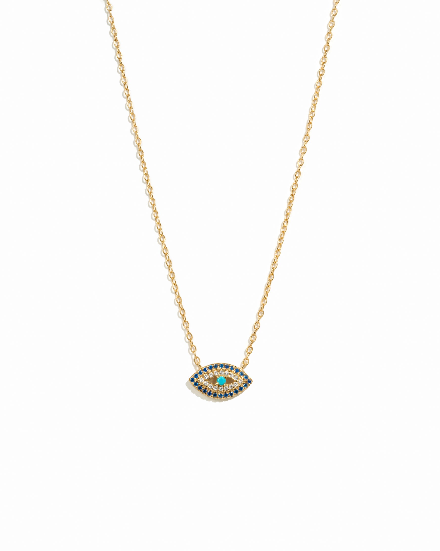 A gold chain necklace featuring a marquise-shaped sapphire evil eye pendant, displayed against a white background.