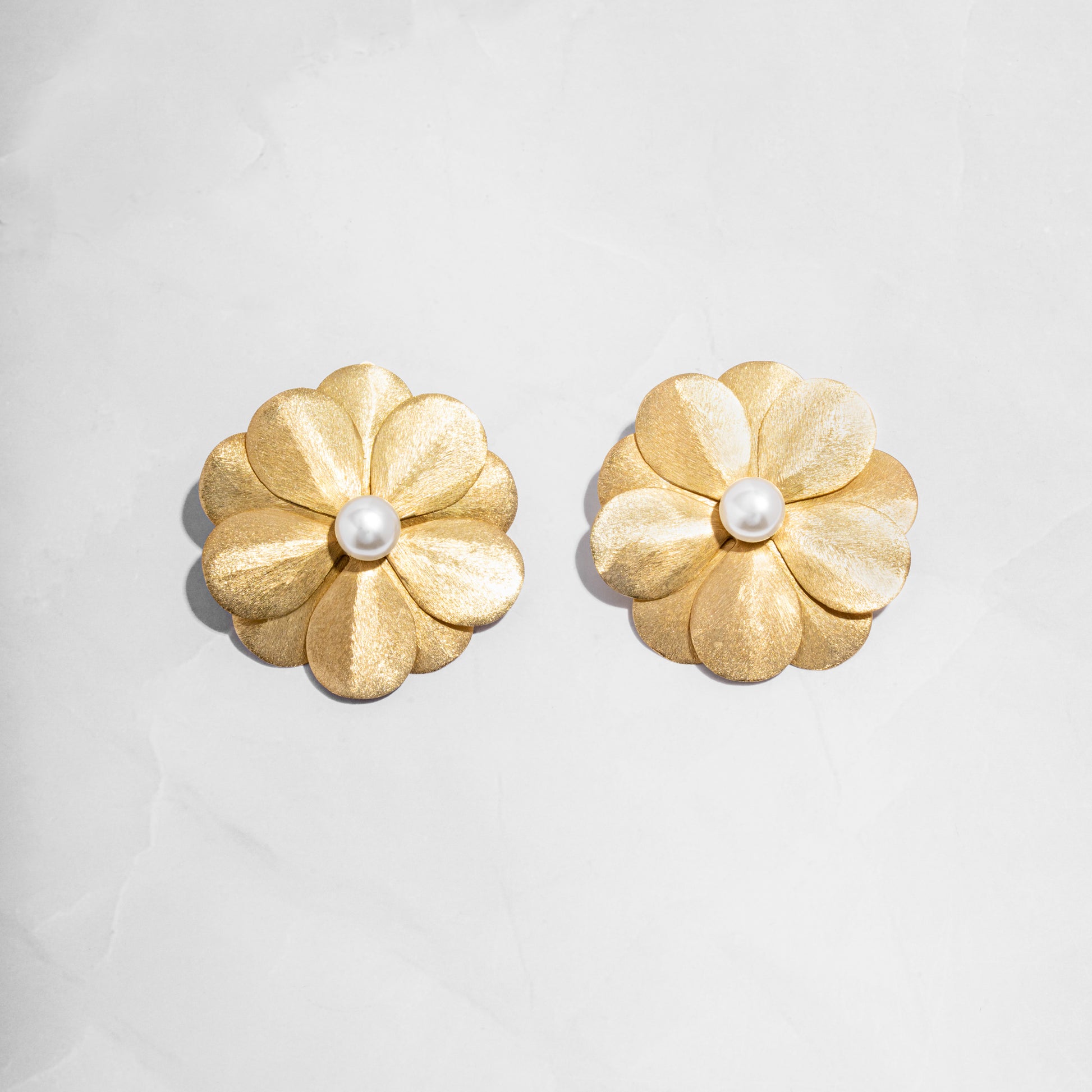 closeup image of gold flower earrings