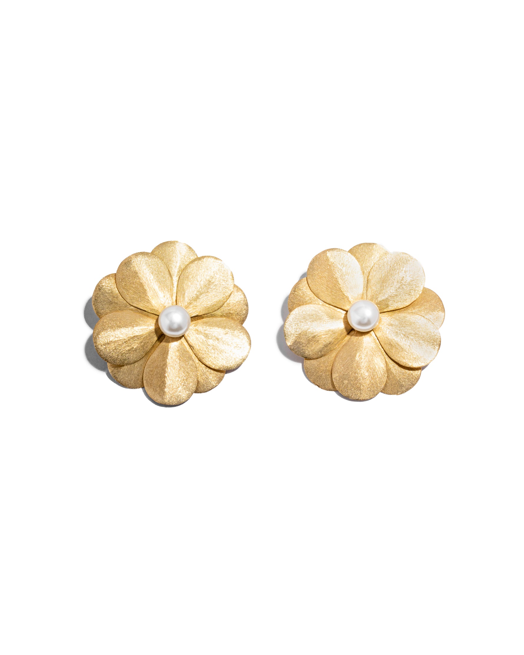closeup image of gold flower earrings