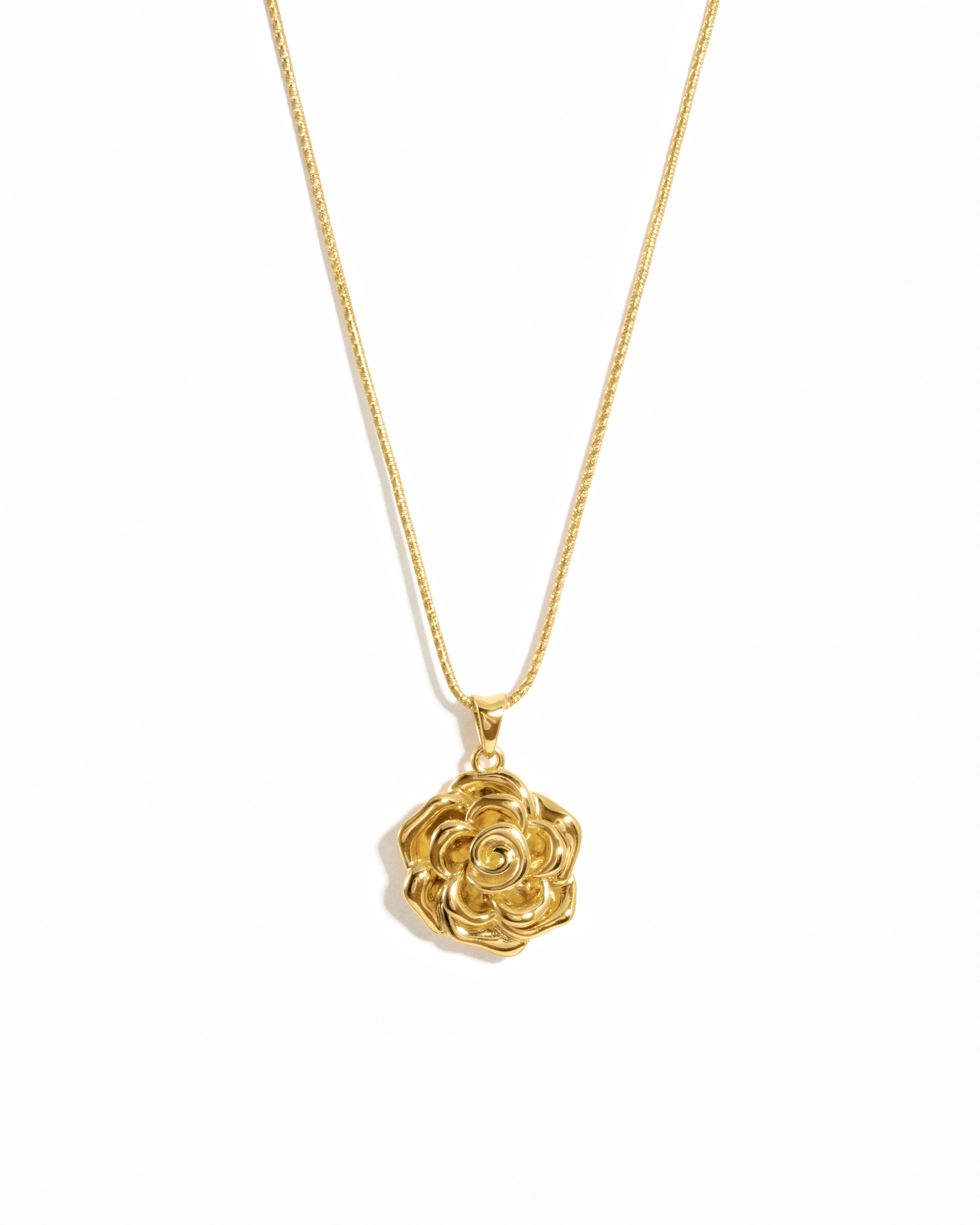 Gold rose-shaped pendant necklace on a white background