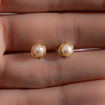 Model showcasing minimalist pearl earrings