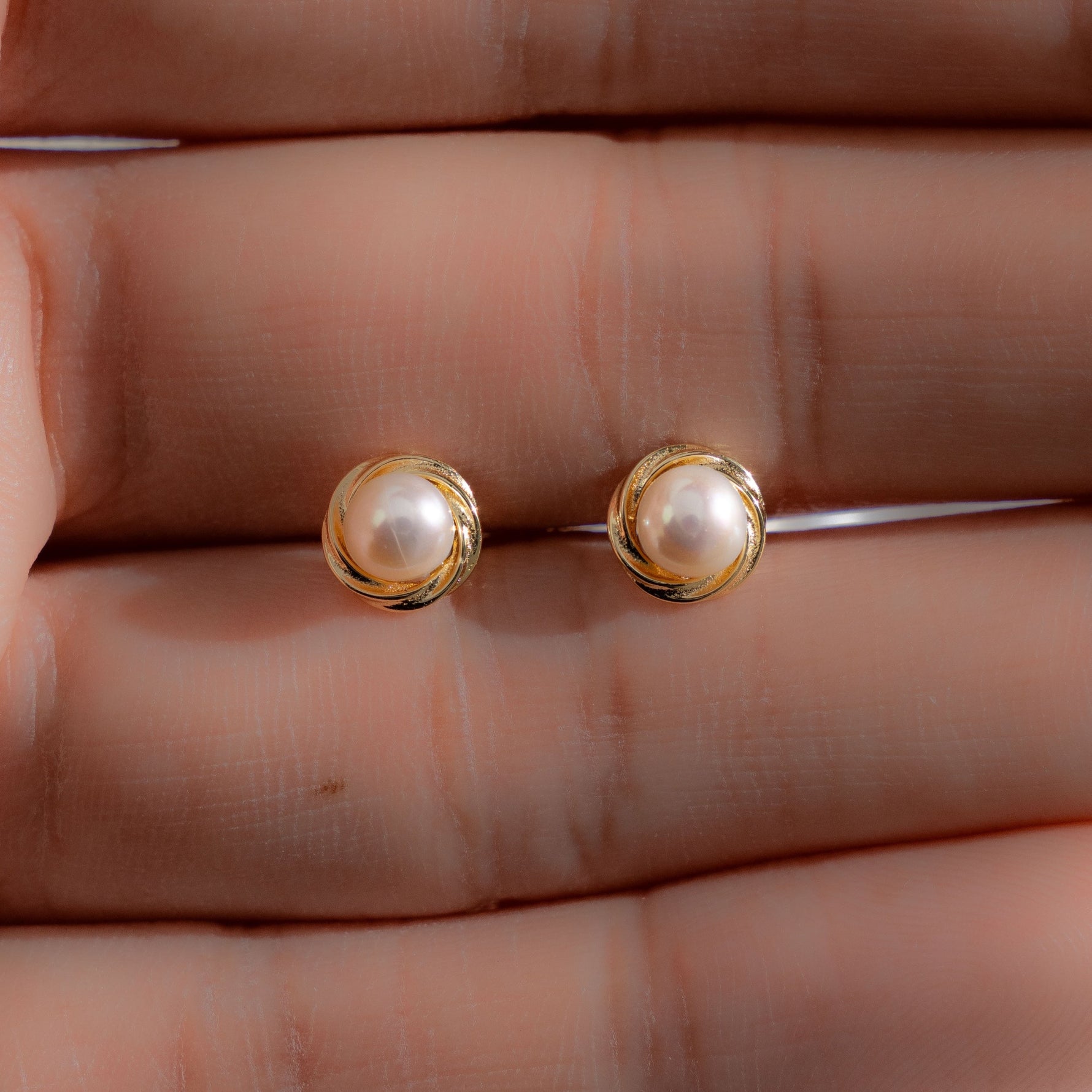 Model showcasing minimalist pearl earrings
