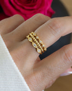 Gold gemstone ring set on models hand
