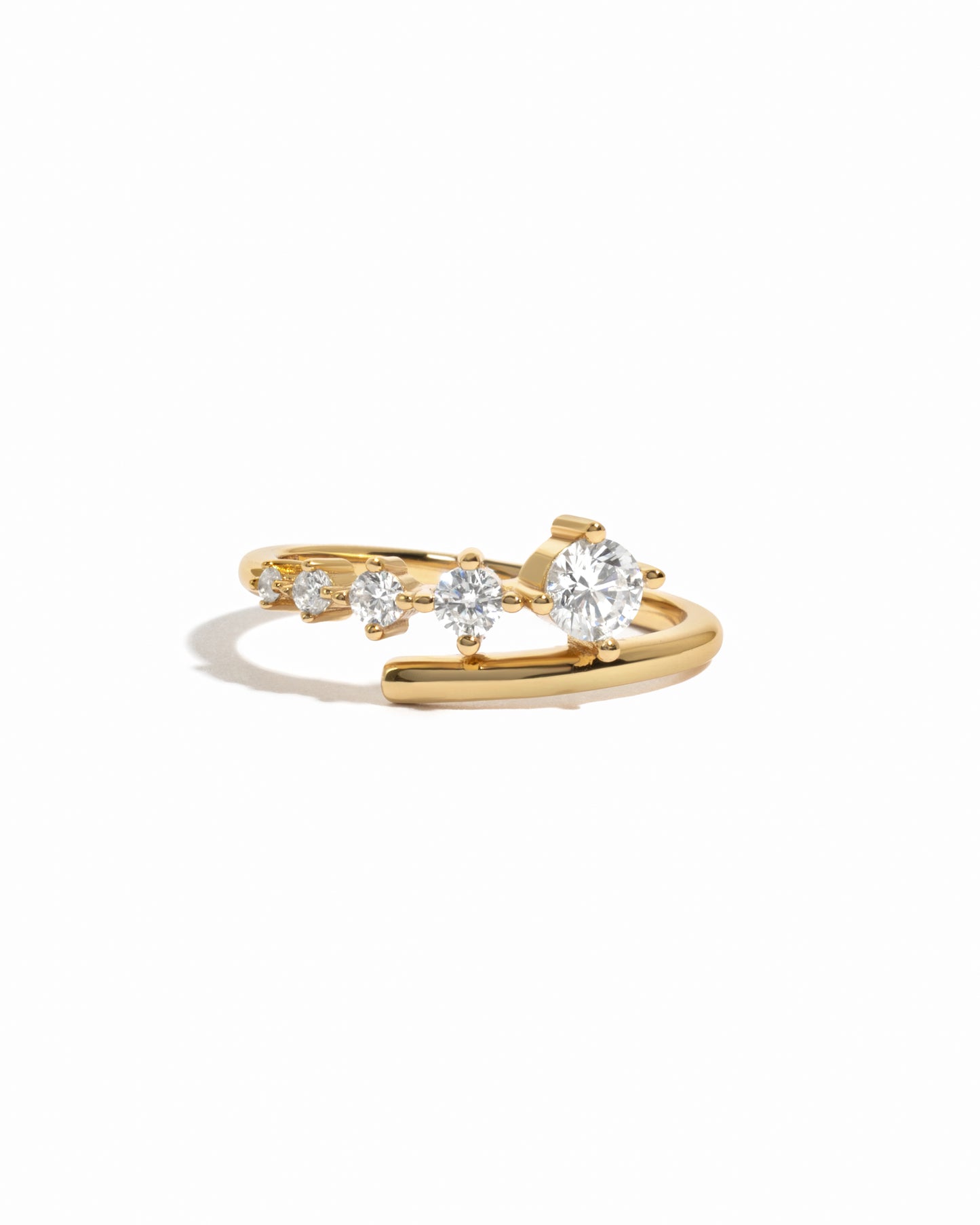 Sami Jewels 14k gold plated bypass ring with multiple cubic zirconia diamonds on a white background