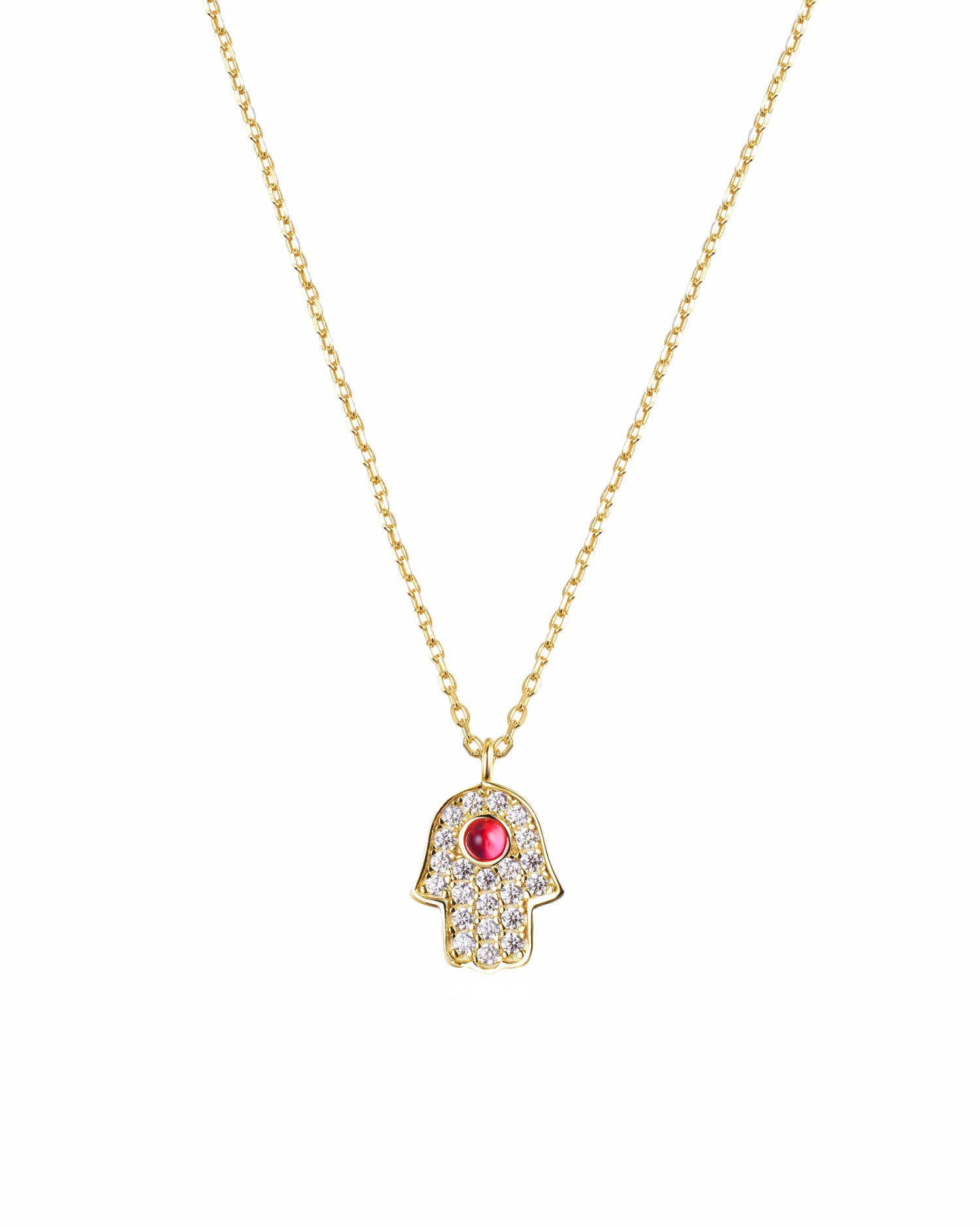 Gold necklace with a hamsa hand pendant featuring a red gemstone on a white background