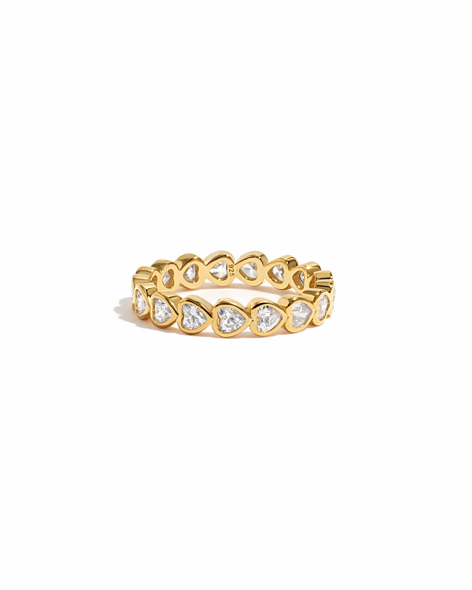 Gold eternity band with diamond hearts on a white background