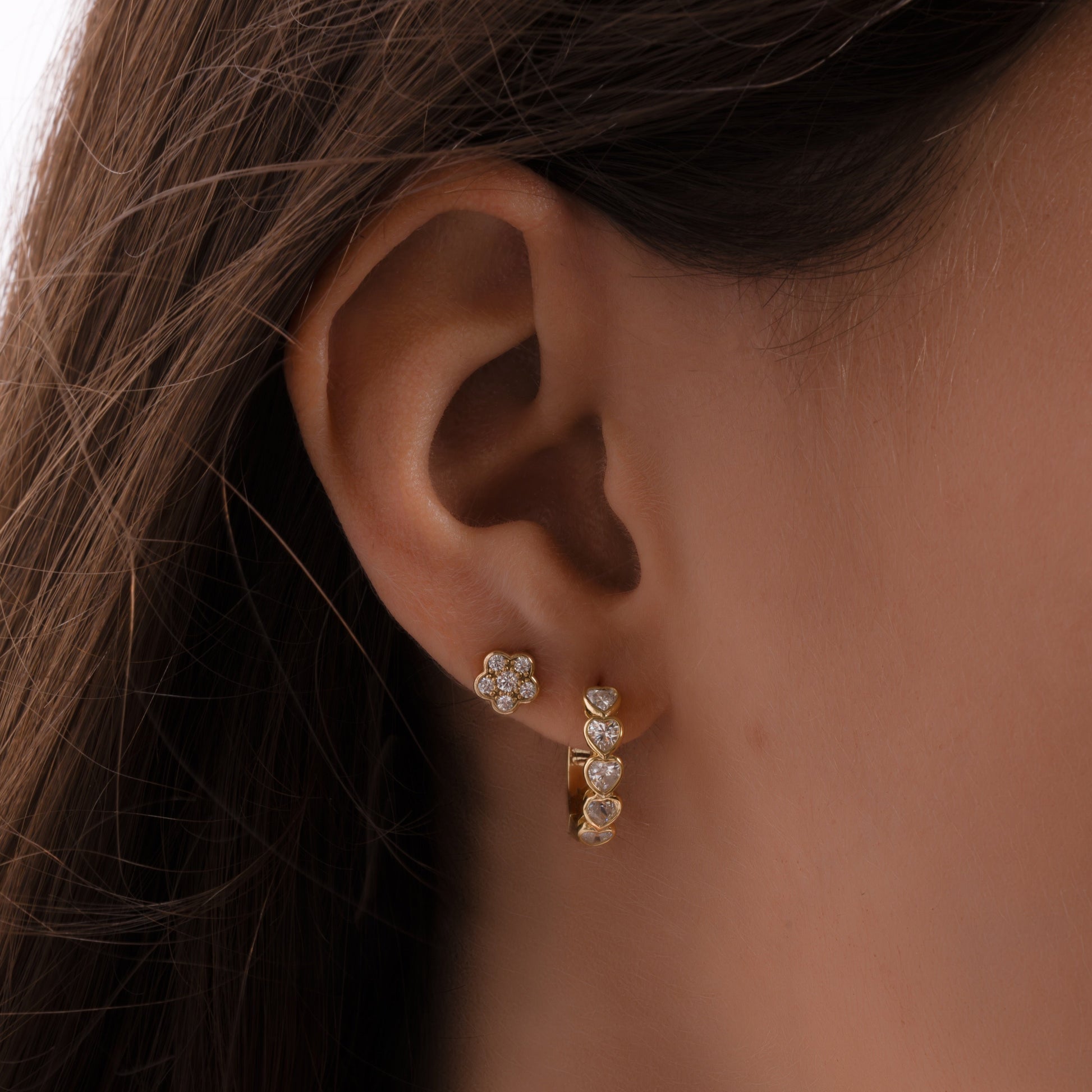 model wearing heart huggie hoop earrings 