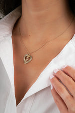 Gold charm necklace with heart rose pendant on model