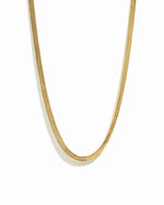 A gold 2mm herringbone chain necklace on a white background