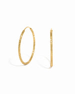 Gold hoop simple everyday earrings on a white background