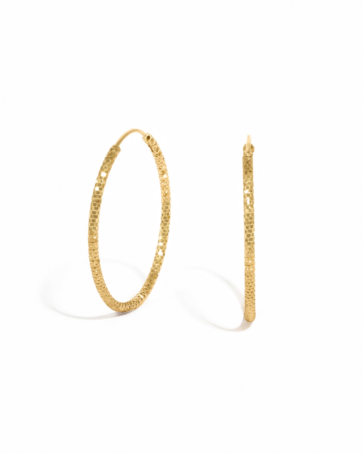 Gold hoop simple everyday earrings on a white background