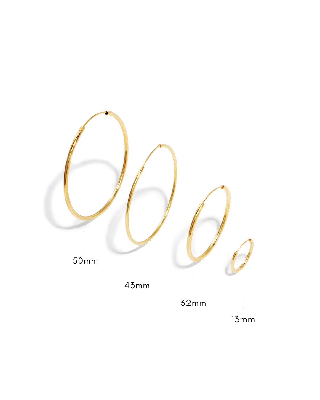 Set of gold hoop earrings with size measurements on a white background