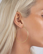 Model wearing 53mm diamond hoop earrings, bold yet lightweight earrings perfect as everyday gold hoops or statement earrings.