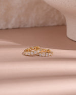 Gold studded hoop earrings by Sami Jewels featuring a bold circular design with metallic studs for a stylish look.