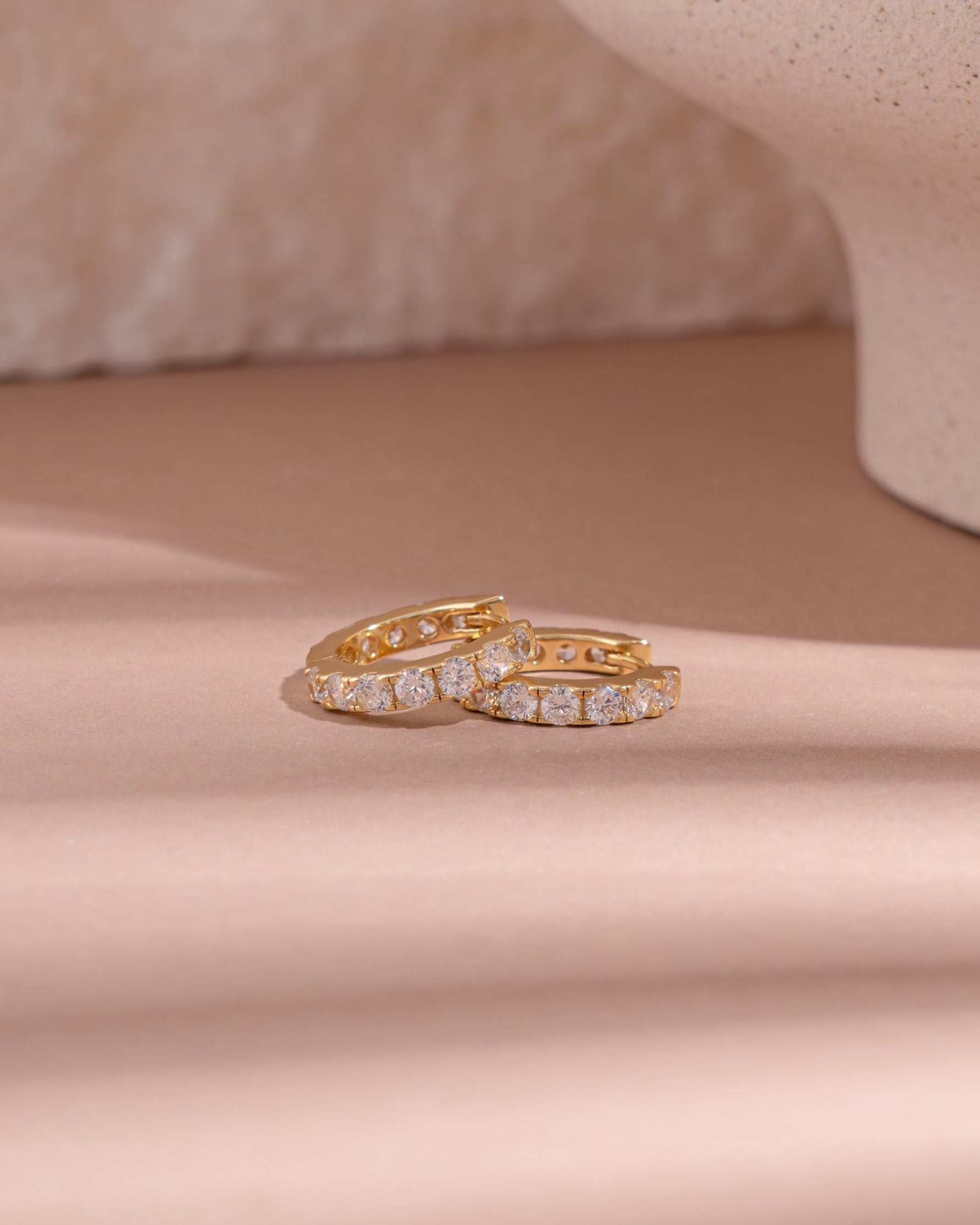 Gold studded hoop earrings by Sami Jewels featuring a bold circular design with metallic studs for a stylish look.