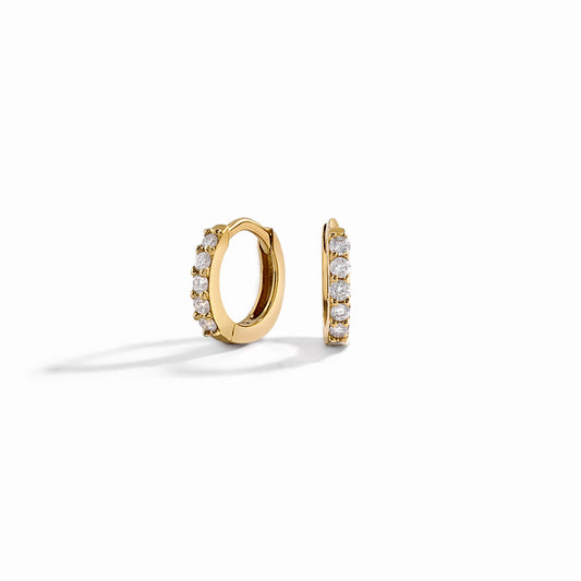 closeup image of mini hoop earrings in gold