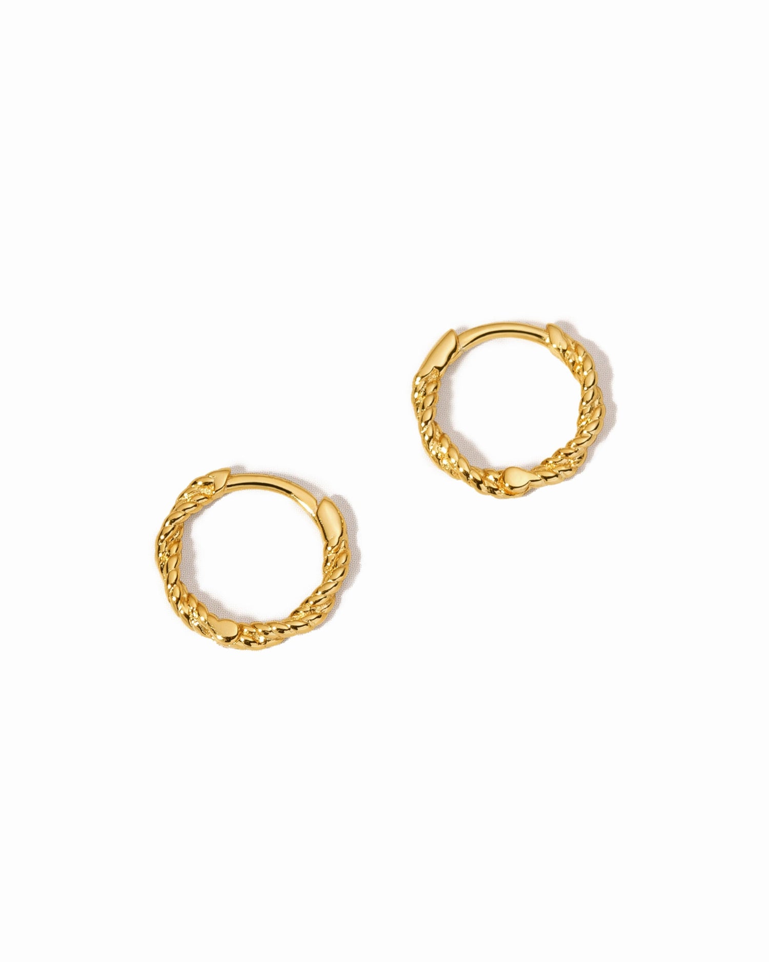 Small gold hoop earrings on a white background