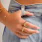 model wearing gold jewelry featuring star dome ring