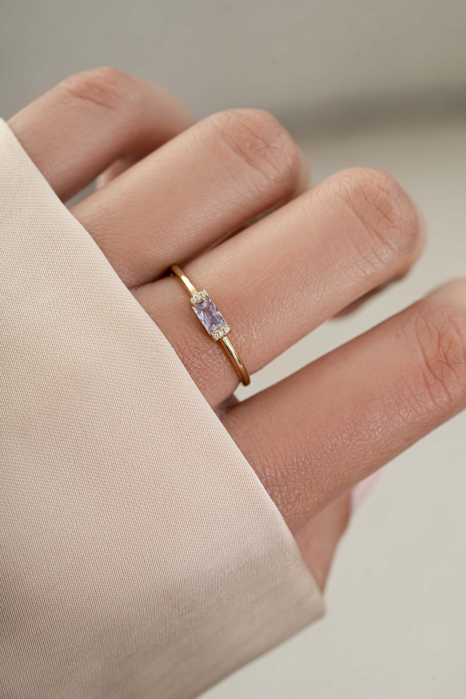 Model wearing gold june birthstone dainty ring