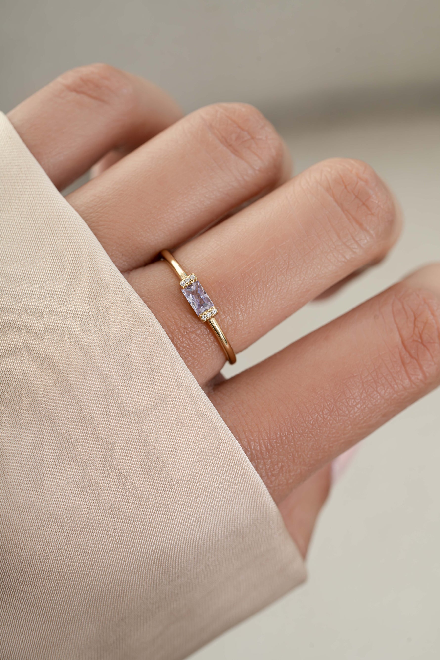 Model wearing gold june birthstone dainty ring