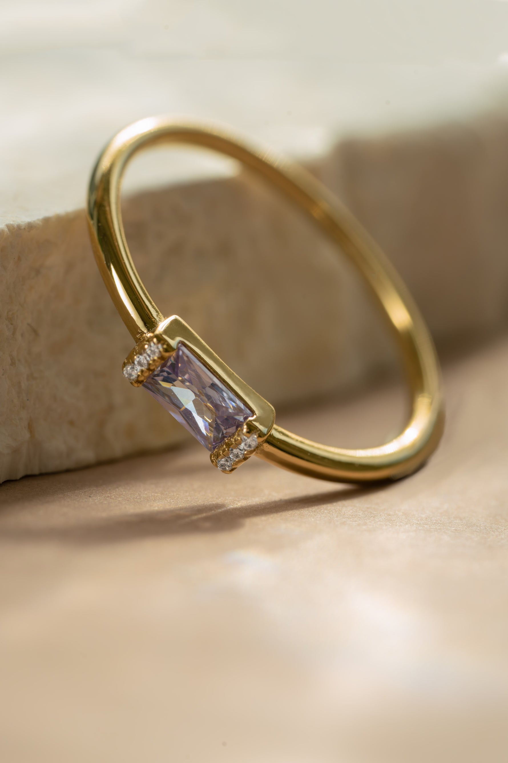 Gold light amethyst diamond baguette ring with a june birthstone