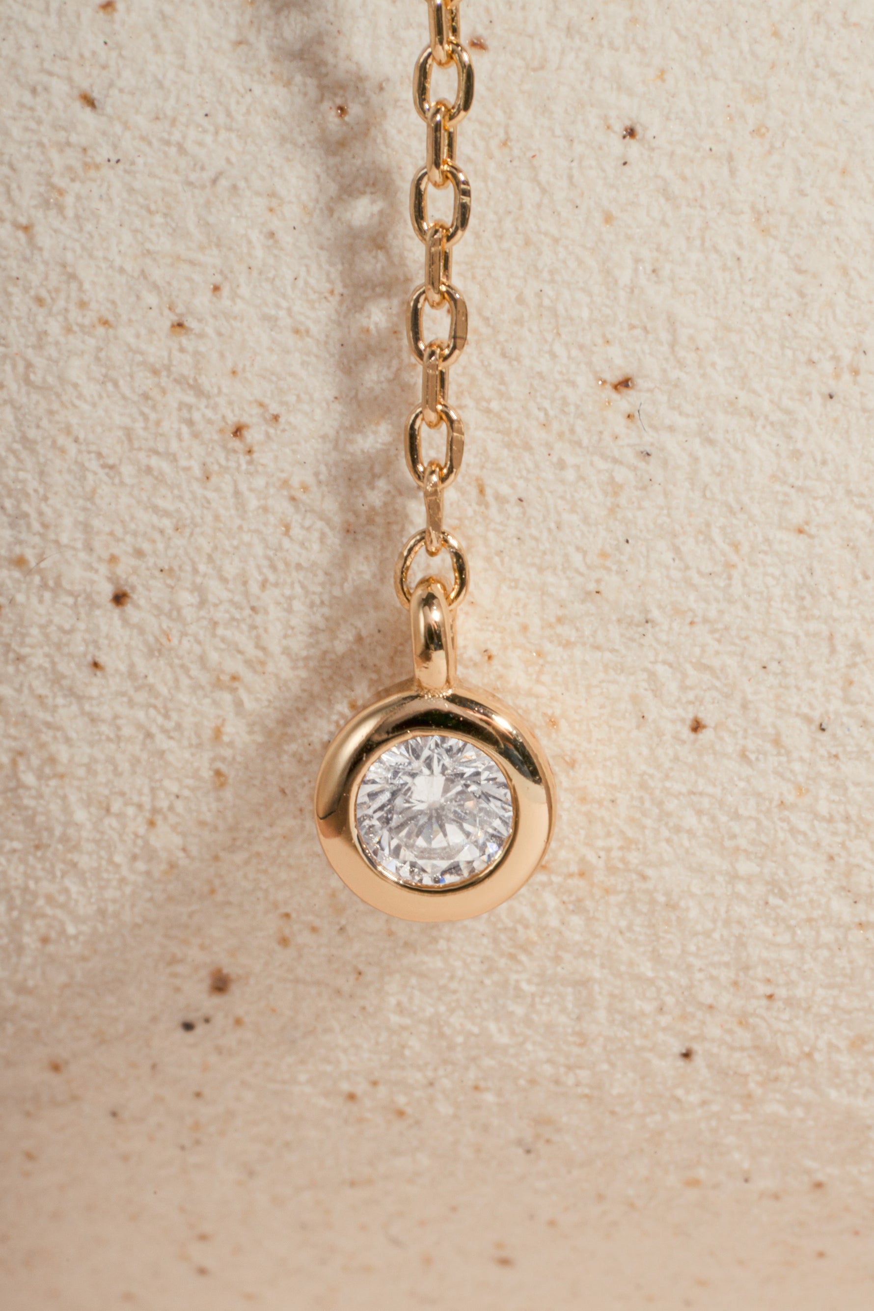 Gold chain necklace with a bezel set diamond pendant