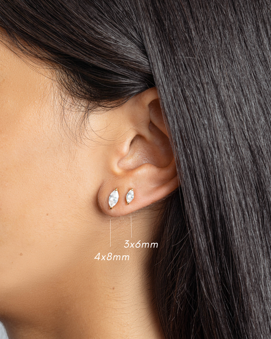Gold stud earrings on model, one dainty earring in 4x8mm, and one minimalist earring in 3x6mm