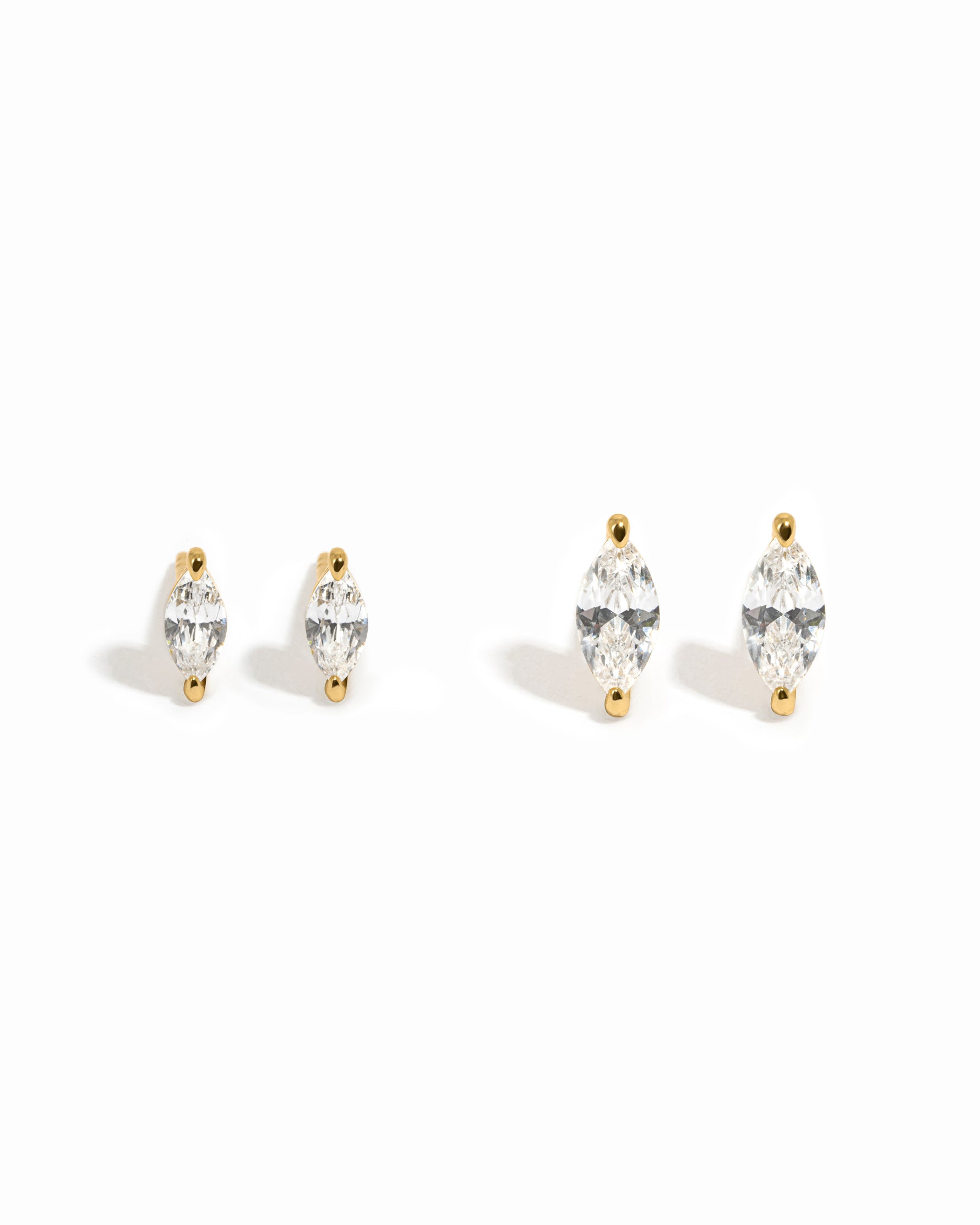 Two pairs of diamond stud earrings  on a white background