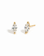 Gold diamond earrings with a white background
