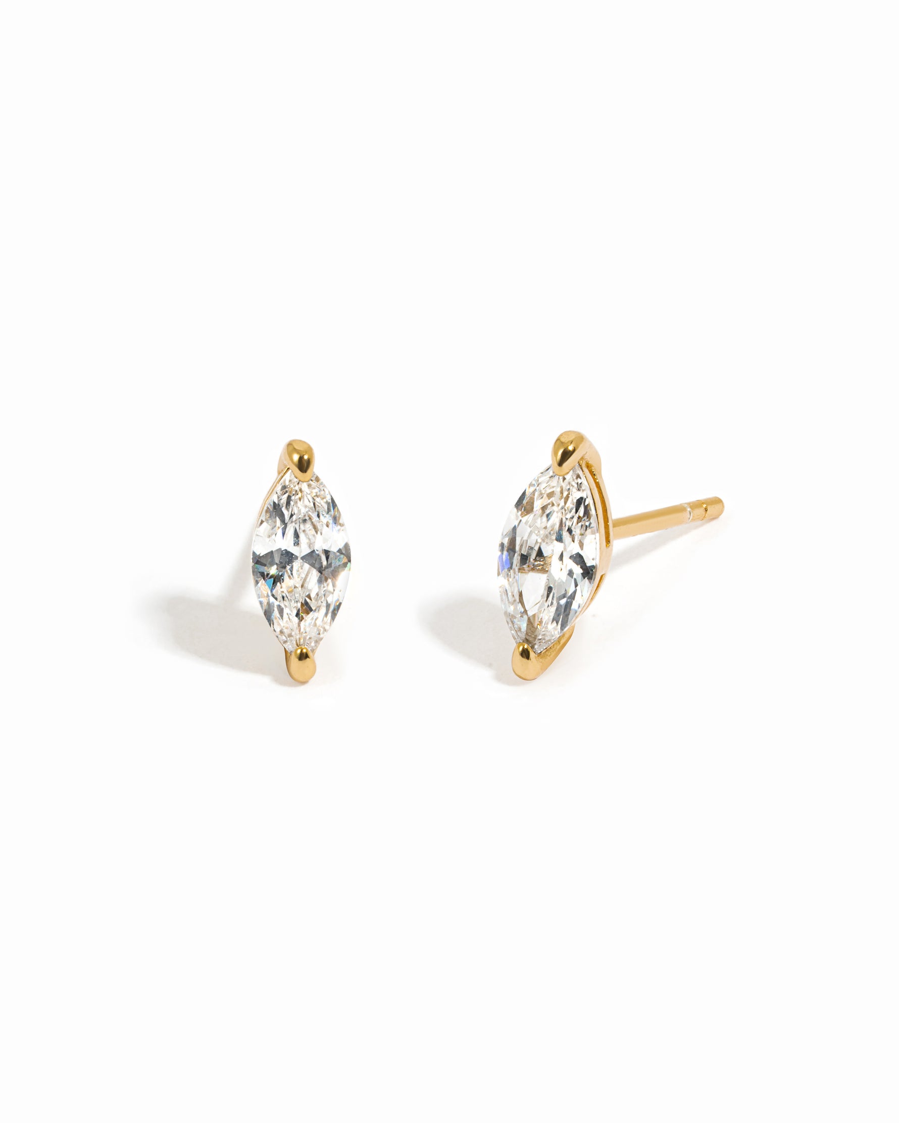 Gold diamond earrings with a white background