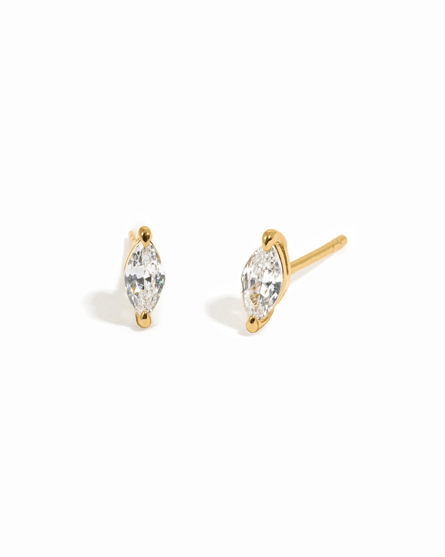Gold stud earrings on a white background