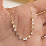 Model holding gold charm necklace with diamonds 
