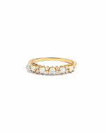 Gold ring with opal  and cz stones on a white background
