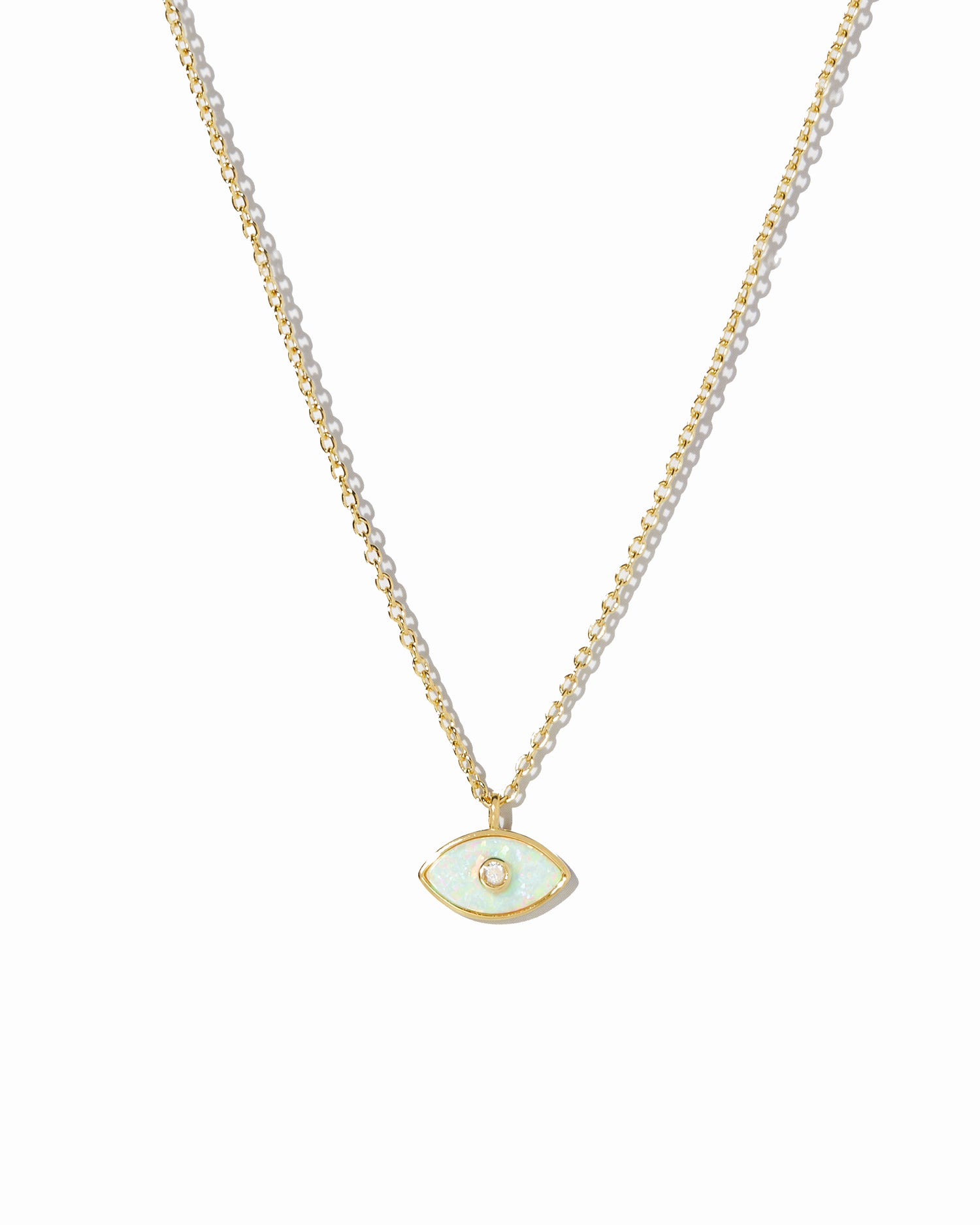 Gold necklace with a small evil eye opal pendant on a white background