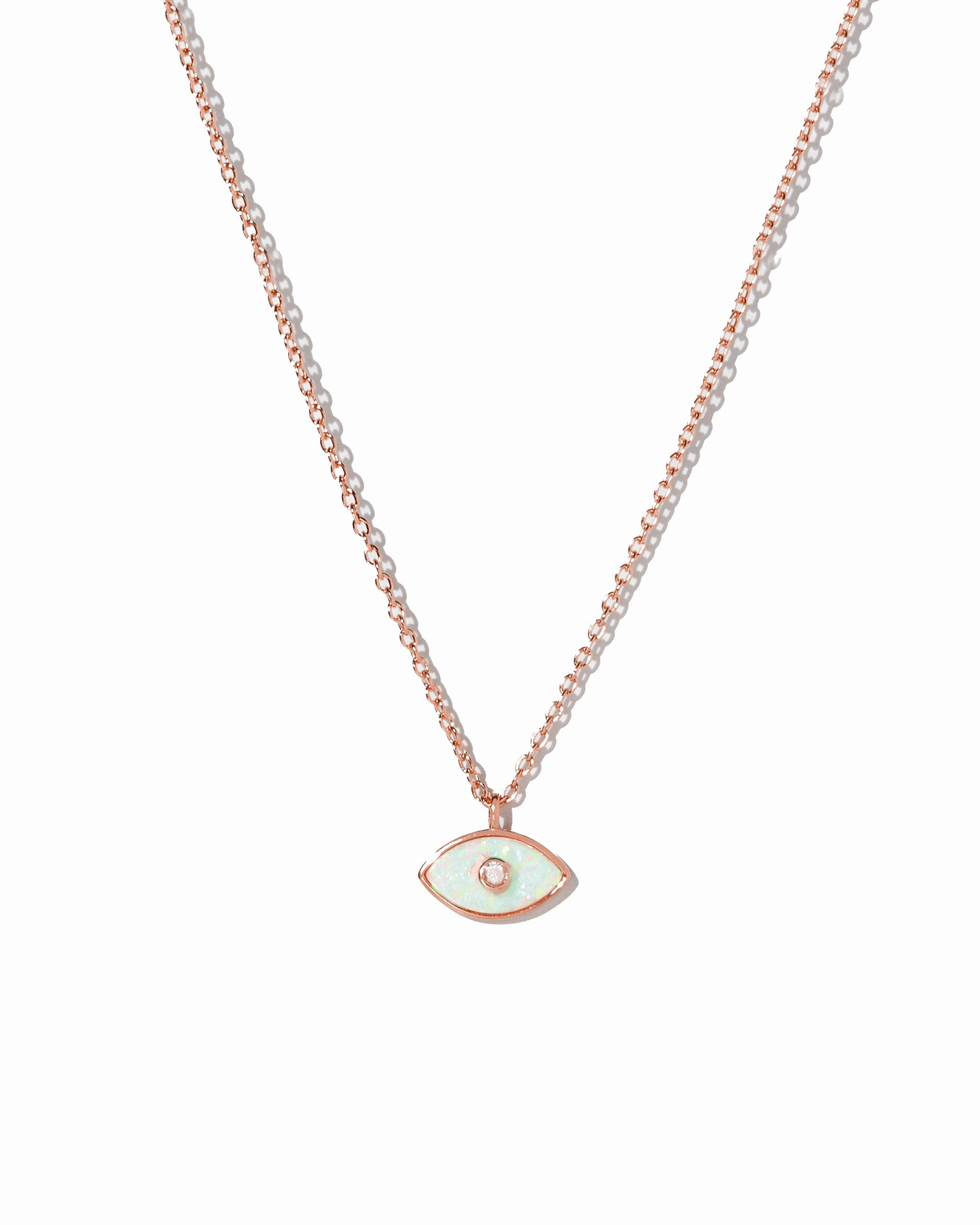 Rose gold evil eye pendant necklace on a white background
