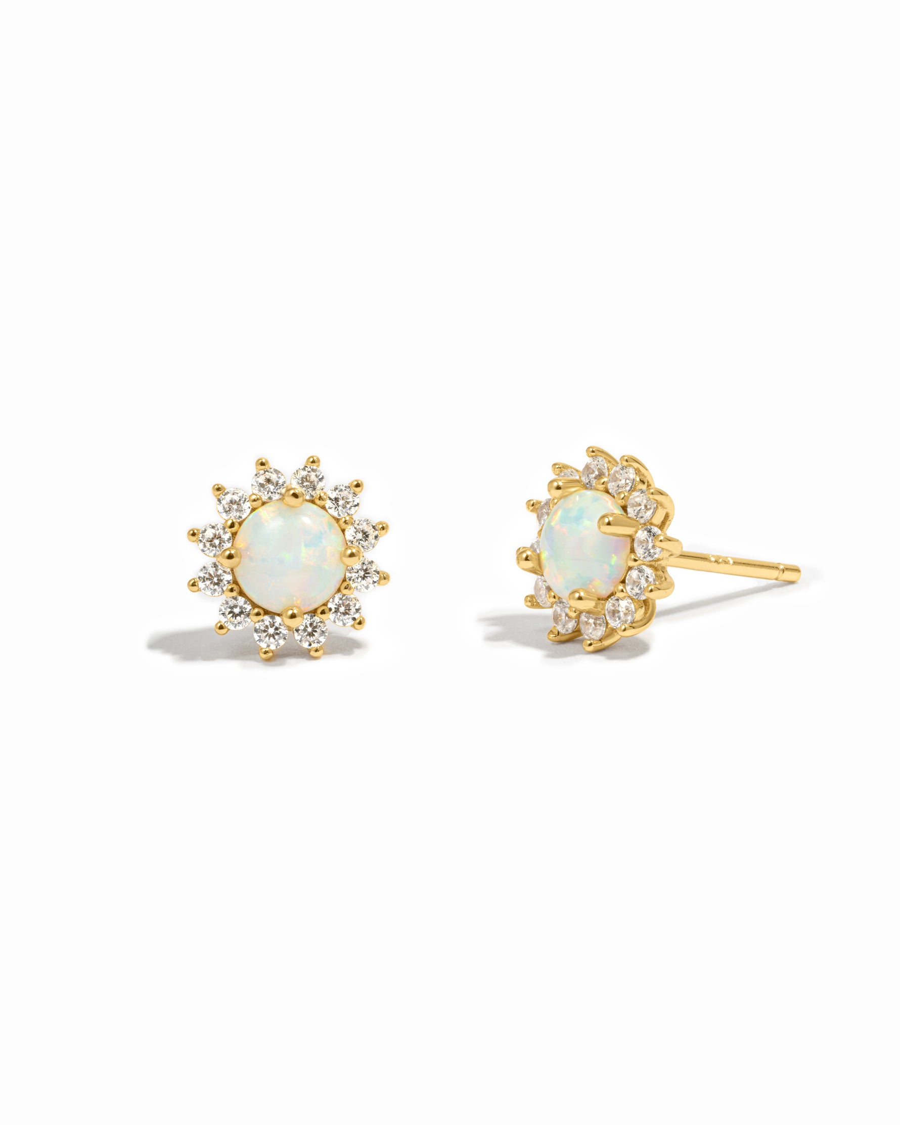 Gold opal stud earrings with diamond halo.