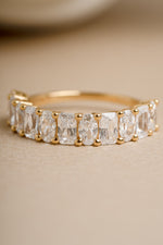 Gold oval cut and diamond cut ring for women on beige background