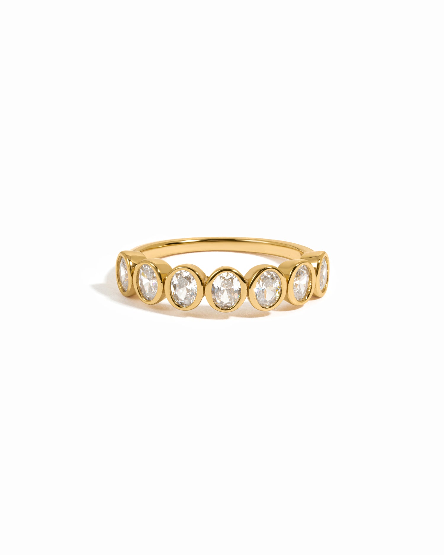 Gold vintage oval bezel set stackable ring on a white background