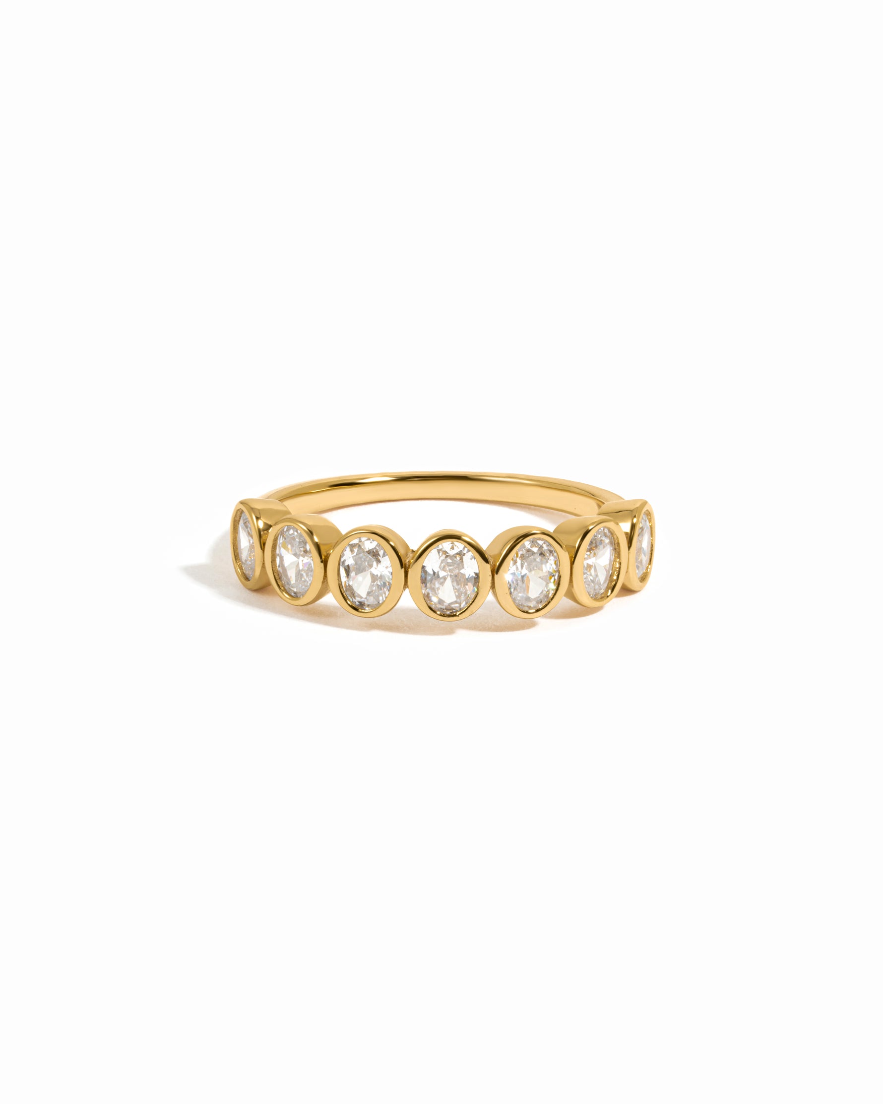 Gold vintage oval bezel set stackable ring on a white background